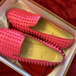 Hot pink Louboutin spiked loafers.